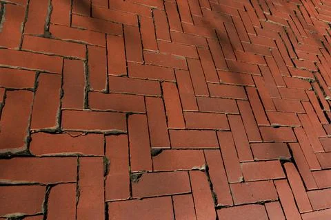 Rustic red clay brick walkway texture, old herringbone pattern street pavement Stock Photos