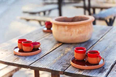 Rustic red clay coffee cups placed on a trays on a wooden table Stock Photos