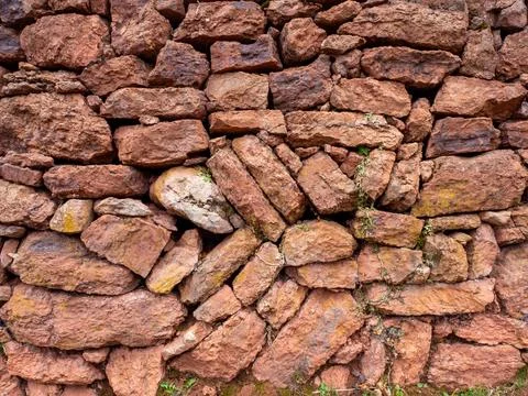 Rustic red dry stone wall background texture Stock Photos
