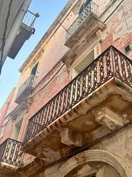 Rustic Red Facade with Balconies in Old Italian Town. Stock Photos