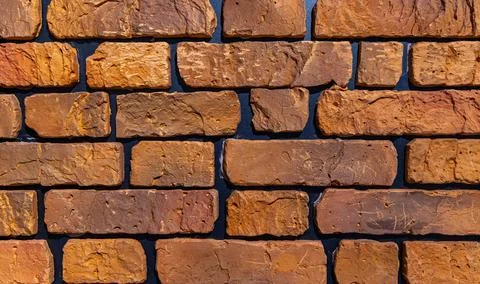 Rustic red-orange brick wall texture background. Stock Photos