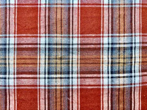 Rustic red plaid fabric texture interwoven blue brown white stripes closeup p Stock Photos