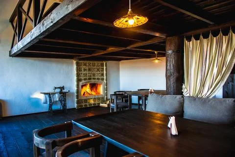 Rustic restaurant interior with tiled fireplace and vintage decor Stock Photos