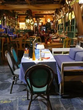 Rustic restaurant interior with warm lighting, wooden elements, checkered t.. 스톡 사진