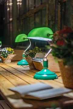 Rustic restaurantcafe setting, wood table with pendant lamps, open book, arti Stock Photos