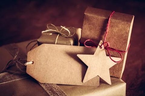 Rustic retro gift, present boxes with tag. Christmas time, eco paper wrap. Stock Photos