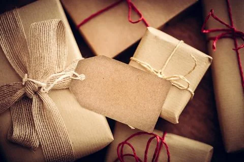 Rustic retro gift, present boxes with tag. Christmas time, eco paper wrap. Stock Photos