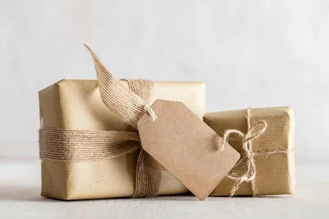 Rustic retro gifts, present boxes with tag. Christmas time, eco paper wrap. Stock Photos