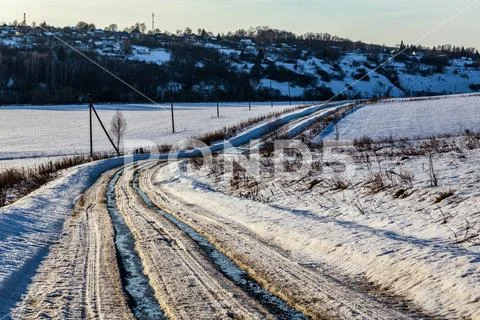 Rustic road track at winter thaw daylight with nobody Stock Photos