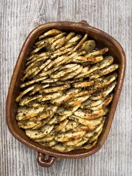 Rustic roasted hasselback potato gratin Stock Photos