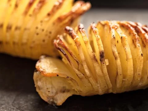 Rustic roasted hasselback potato gratin Stock Photos