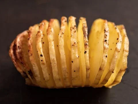 Rustic roasted hasselback potato gratin Stock Photos