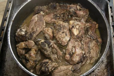 Rustic roasted lamb pieces in pan Stock Photos