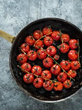Rustic roasted red summer cherry tomato Stock Photos