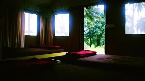 Rustic room interior with beds and open windows revealing a vibrant jungle .. 스톡 동영상 341349796