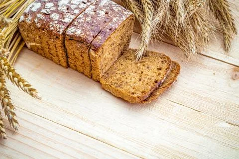 Rustic rye. Fresh loaf of rustic traditional bread with wheat grain ear or sp Stock Photos