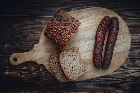 Rustic Rye Whole Grain Bread and Sausages on Wooden Serving Board Stock Photos