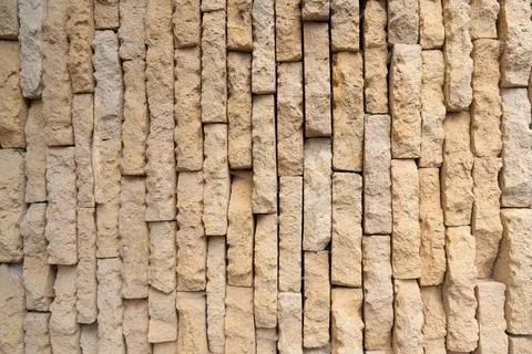 Rustic sandstone wall texture with weathered irregular warm blocks Stock Photos