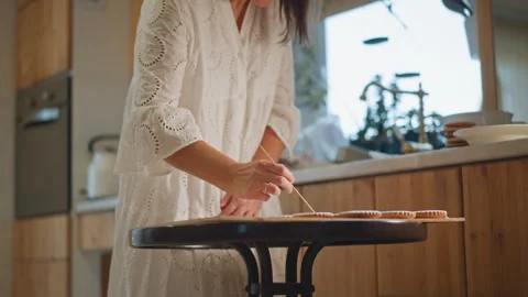 Rustic scene with woman preparing pumpkin pie delights. Gentle sunlight Stock Footage 346404502