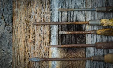 Rustic screwdrivers on wood background Stock Photos