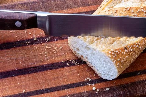Rustic Seeded Bread and Knife on Wooden Cutting Board Stock Photos