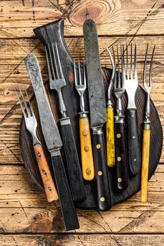 Rustic set of cutlery knife and fork. Wooden background. Top view Stock Photos