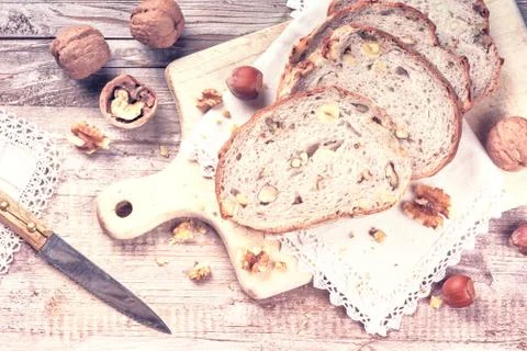 Rustic setting with fresh walnut and hazelnut bread slices Stock Photos