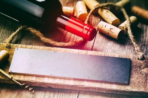 Rustic setting with red wine bottle and corks Stock Photos