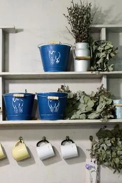 Rustic shelf with blue buckets and eucalyptus Stock Photos