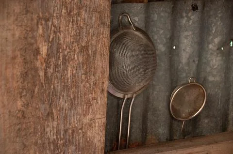 Rustic Sieves between Wood &amp;amp; Corrugated Metal in an Outdoor Kitchen Stock Photos