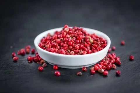 Rustic slate slab with Pink Peppercorns, selective focus Stock Photos