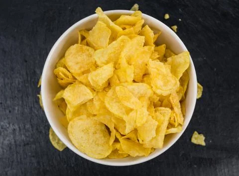 Rustic slate slab with Potato Chips (Cheese and Onoion taste) (selective focu Stock Photos