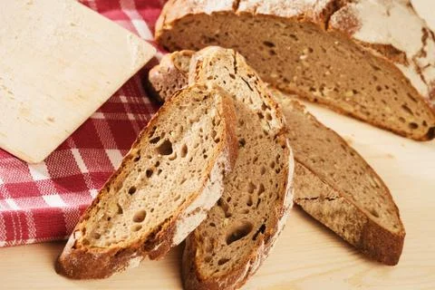 Rustic sliced bread with a towel from top Stock Photos