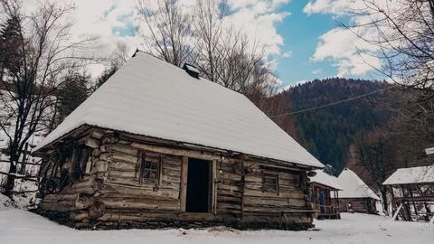 Rustic Snow-Covered Cabin in Winter Landscape Stock Photos