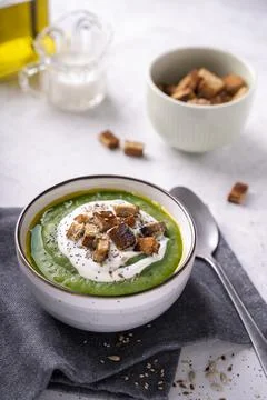 Rustic spinach and broccoli rich soup puree with cream and croutons Stock Photos