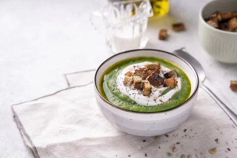 Rustic spinach and broccoli rich soup puree with cream and croutons Stock Photos