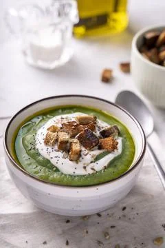 Rustic spinach and broccoli rich soup puree with cream and croutons Stock Photos