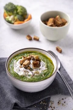 Rustic spinach and broccoli rich soup puree with cream and croutons Stock Photos