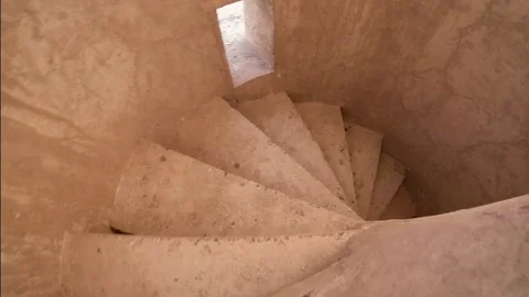 Rustic spiral concrete stairs aged over the years Stock Footage 76464661