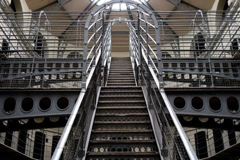 Rustic spiral staircase leading to the upper level of a historical building.. Stock Photos