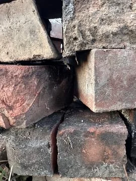 Rustic Stack of Aged Bricks with Cracks and Gaps Stock Photos