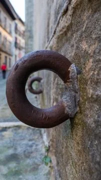 Rustic steel ring on stone wall. Stock Photos