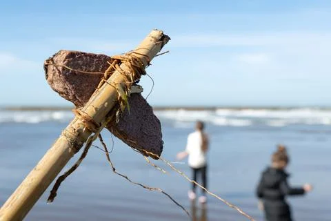 Rustic stick holds weathered, brown, dried leaf Stock Photos