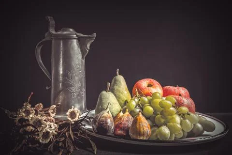 Rustic still life with apples, grapes, pears, and sunflowers. Autumn mood Stock Photos