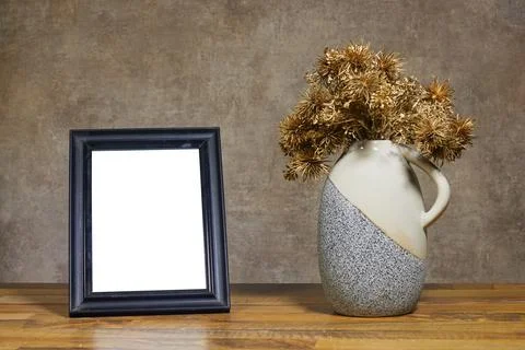 Rustic Still Life With Blank Black Frame And Ceramic Vase Of Dried Gold Flowers  Stock Photos