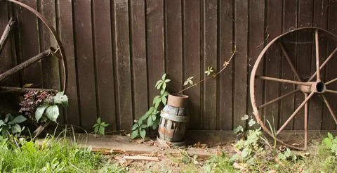 Rustic still life. two old wheels and lamp on wood background Stock Illustration