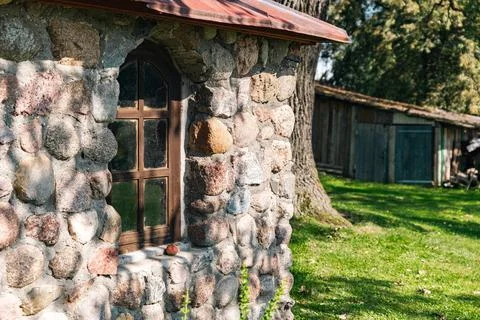 Rustic stone building with a charming window. The wall is built from irregu.. Stock Photos