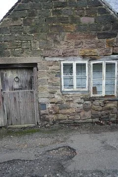 Rustic Stone Cottage Wall With Weathered Door And Windows, Belper, England. Stock Photos