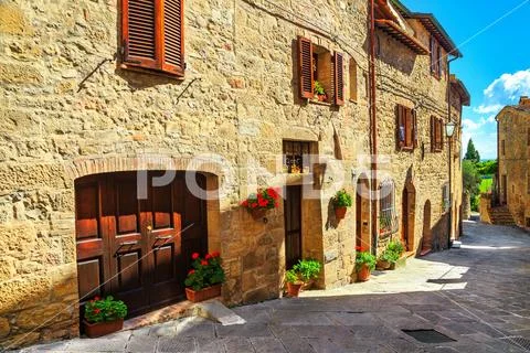Rustic stone houses decorated with colorful flowers, Monticchiello, Tuscany, Stock Photos