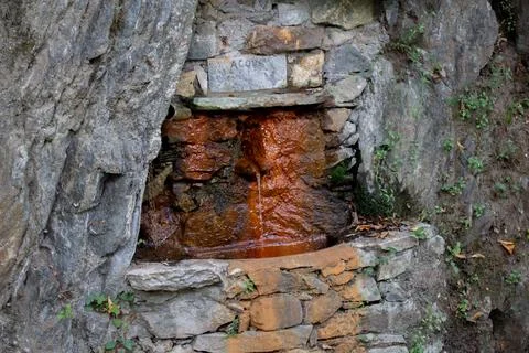 Rustic Stone Spring With Natural Water Flowing From a Rock Formation Stock Photos